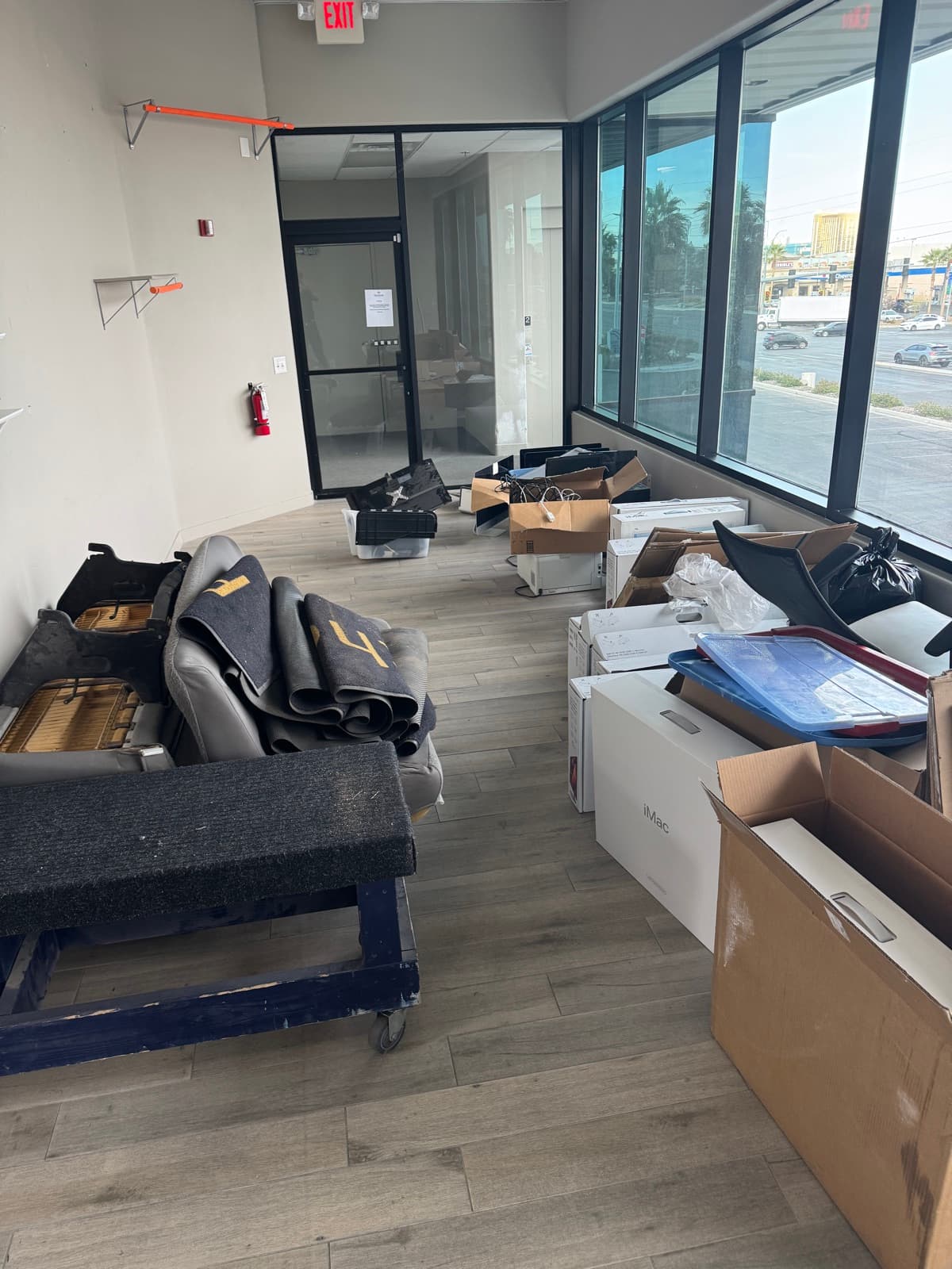 Commercial office suite filled with old carpet, boxes, and debris before JunkMD LV cleanout